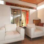 Linen lounge chair in a living room with a low table beside it