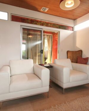 Linen lounge chair in a living room with a low table beside it
