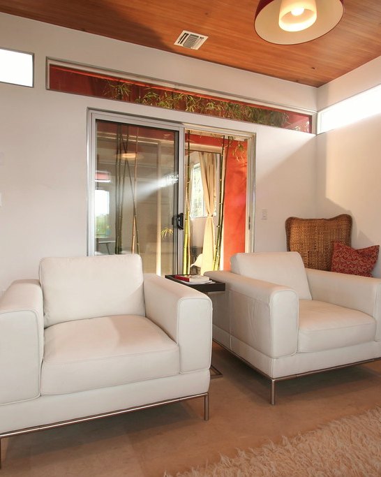 Linen lounge chair in a living room with a low table beside it