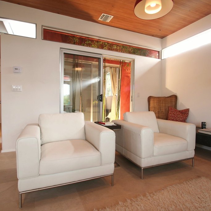 Linen lounge chair in a living room with a low table beside it