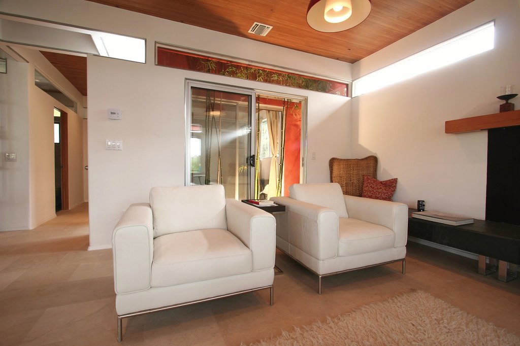 Linen lounge chair in a living room with a low table beside it