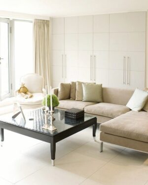 Three seat boucle sofa against a warm wall