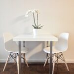 Ash dining table with two chairs in a dining room