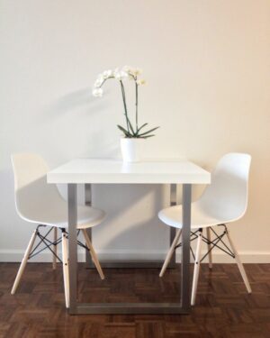 Ash dining table with two chairs in a dining room