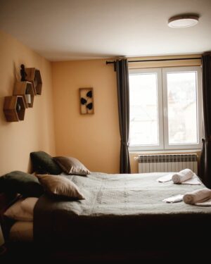 Walnut bed frame with linen bedding in a calm bedroom