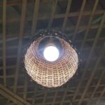 Oak dome pendant lamp hanging over a table