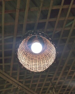 Oak dome pendant lamp hanging over a table