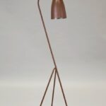 Paper floor lamp with oak base beside a chair