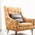 Saffron wool wingback armchair beside a bright doorway
